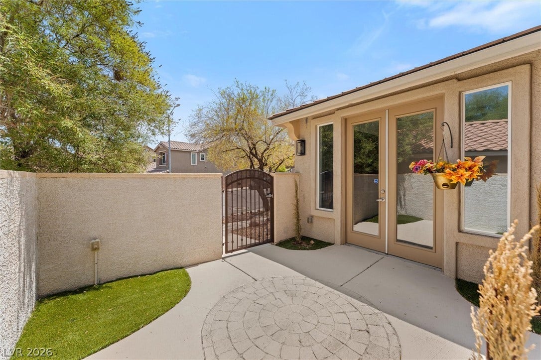 215 Sunset Shower Drive, Henderson, NV 89012 Double glass doors open onto a private courtyard with circular stone paving.