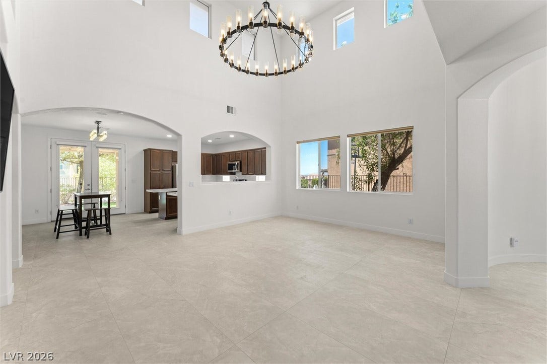 215 Sunset Shower Drive, Henderson, NV 89012 Double-height ceilings and arched transitions define this airy main-level living space.