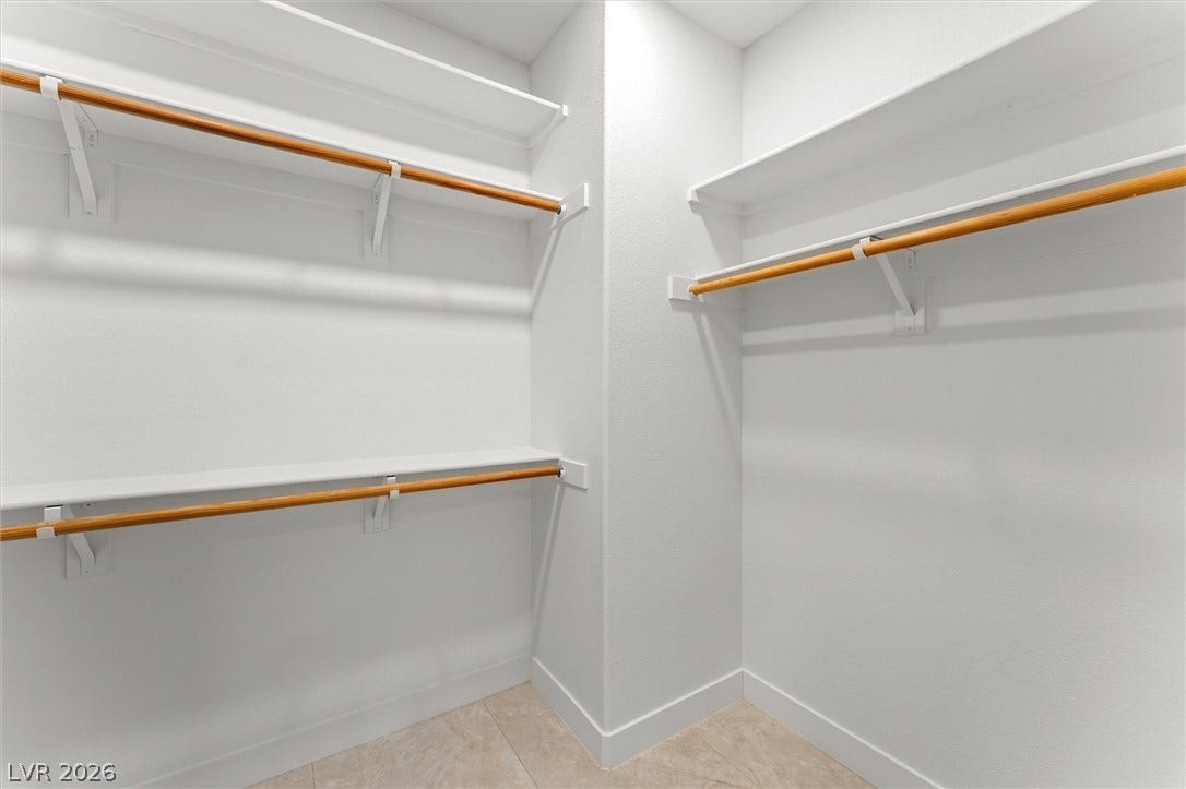 215 Sunset Shower Drive, Henderson, NV 89012 Ample built-in shelving and hanging rods maximize storage efficiency in this closet space.