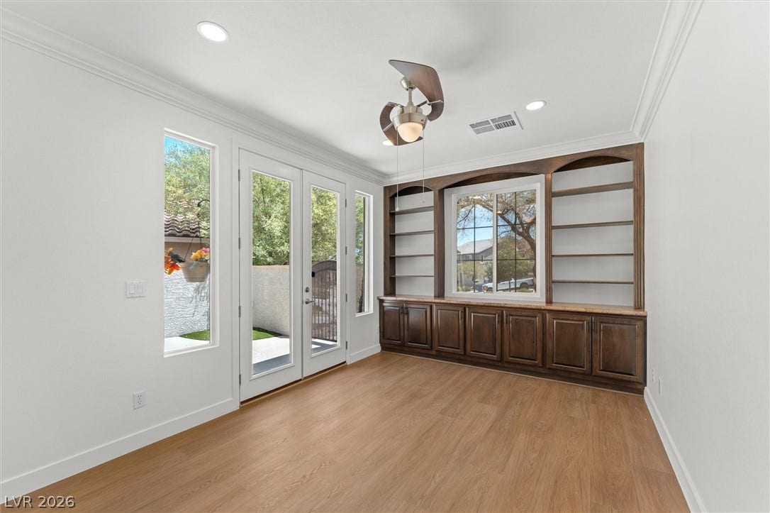 215 Sunset Shower Drive, Henderson, NV 89012 Gleaming hardwood floors and customized dark wood built-ins define this versatile, light-filled space.