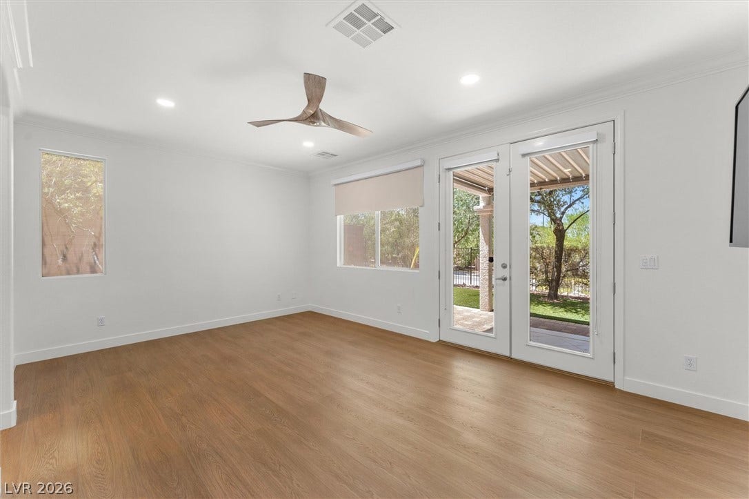 215 Sunset Shower Drive, Henderson, NV 89012 Rich wood flooring runs throughout this versatile living space featuring glass French doors.