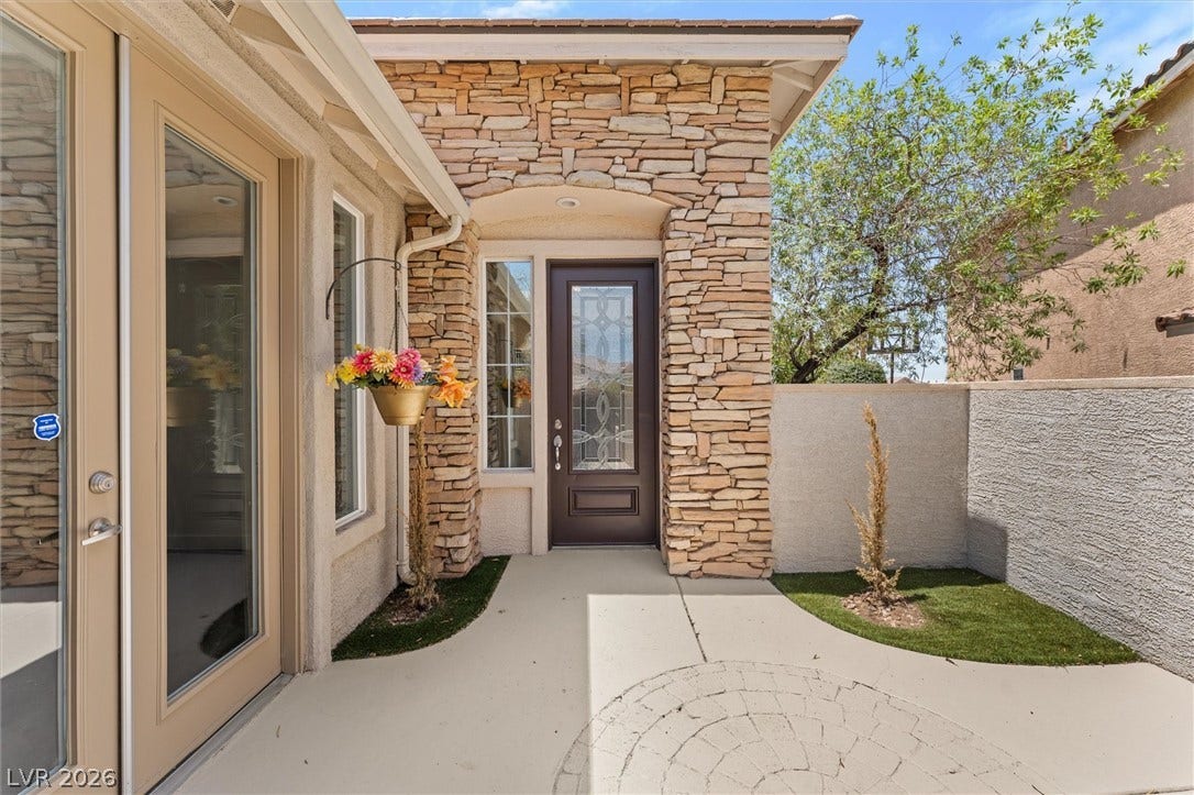 215 Sunset Shower Drive, Henderson, NV 89012 Natural stone accents and a paved courtyard welcome guests to the front entry.