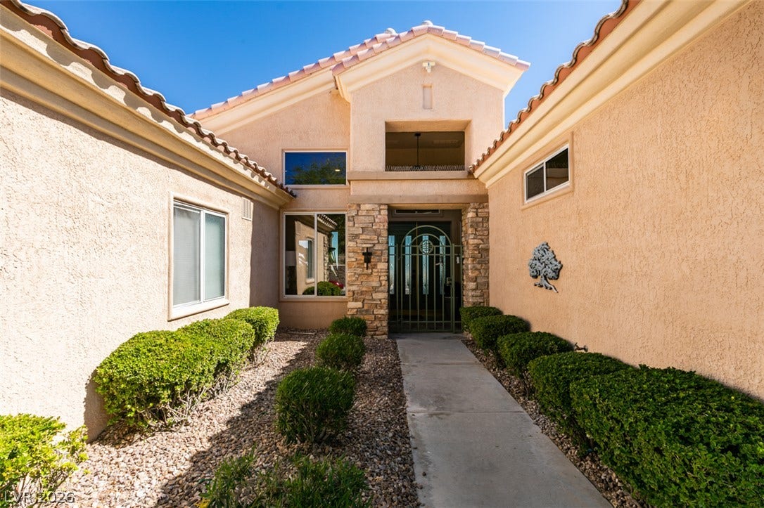 2532 Faiss Drive, Las Vegas, NV 89134 A welcoming concrete walkway leads directly to the stone-accented front entryway.