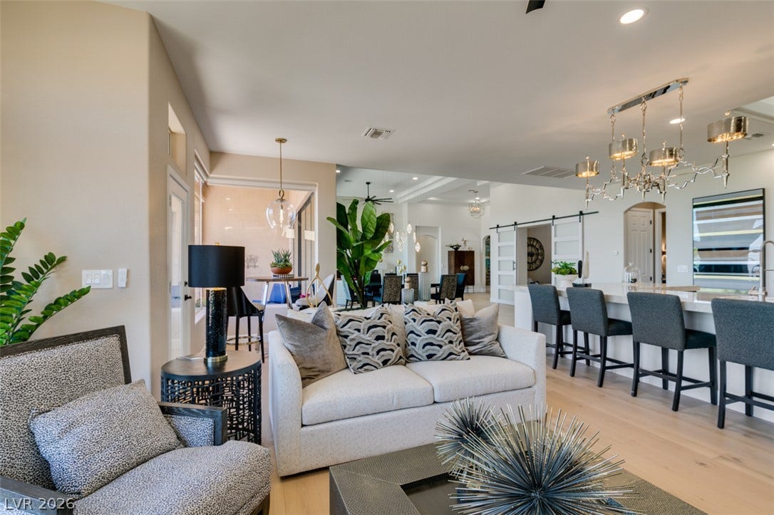 2532 Faiss Drive, Las Vegas, NV 89134 Smooth wood floors flow through this light-filled open layout under recessed lighting.
