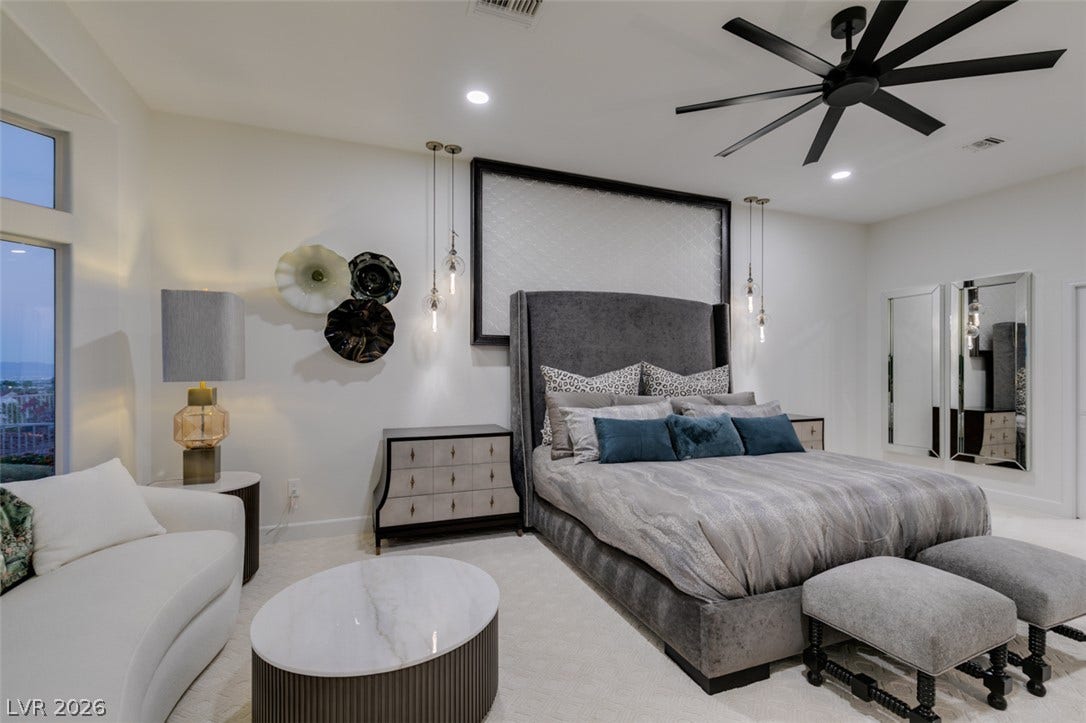 2532 Faiss Drive, Las Vegas, NV 89134 Gleaming recessed lighting and towering windows elevate this refined bedroom space.