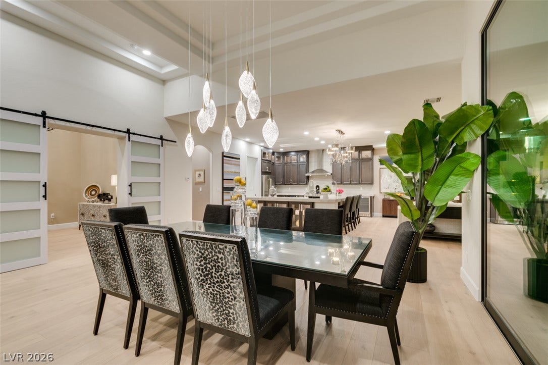 2532 Faiss Drive, Las Vegas, NV 89134 High ceilings and light wood floors elevate this expansive open-concept dining area.