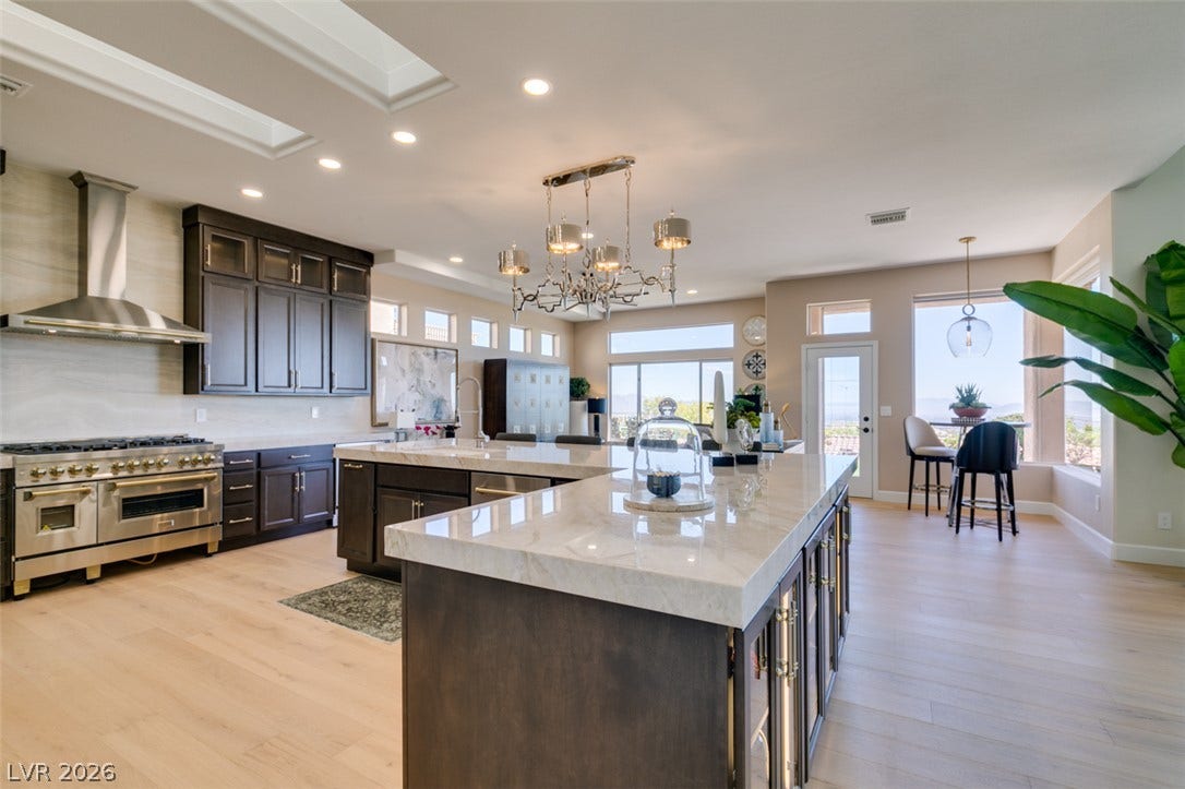 2532 Faiss Drive, Las Vegas, NV 89134 Polished stone countertops and high-end built-in appliances anchor this spacious open-concept culinary space.
