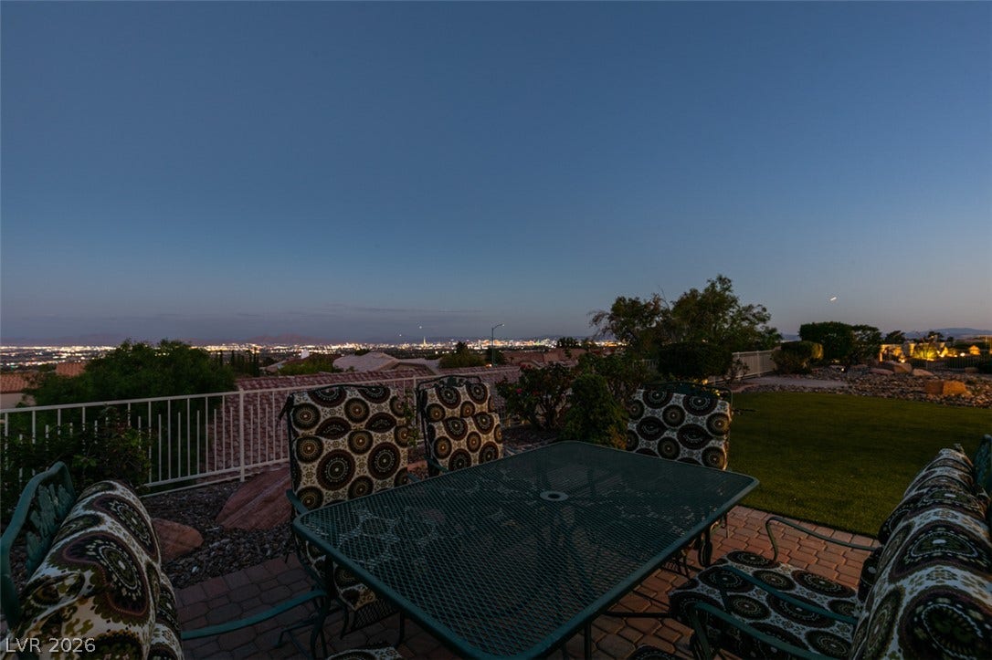 2532 Faiss Drive, Las Vegas, NV 89134 Distant city lights shimmer across the horizon from this elevated backyard vantage point.