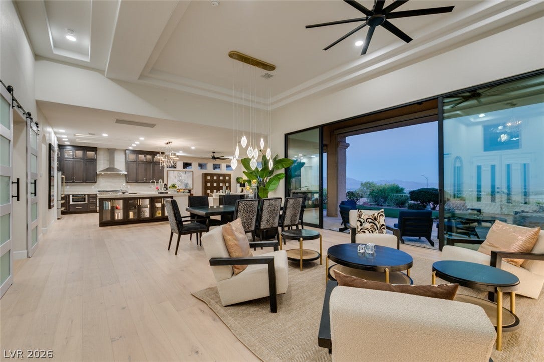 2532 Faiss Drive, Las Vegas, NV 89134 Gleaming wood floors and a soaring tray ceiling anchor this seamless open-concept living space.