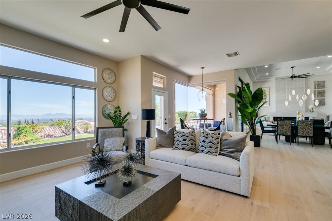 2532 Faiss Drive, Las Vegas, NV 89134 Generous windows frame distant mountain views from this airy open-concept living space.