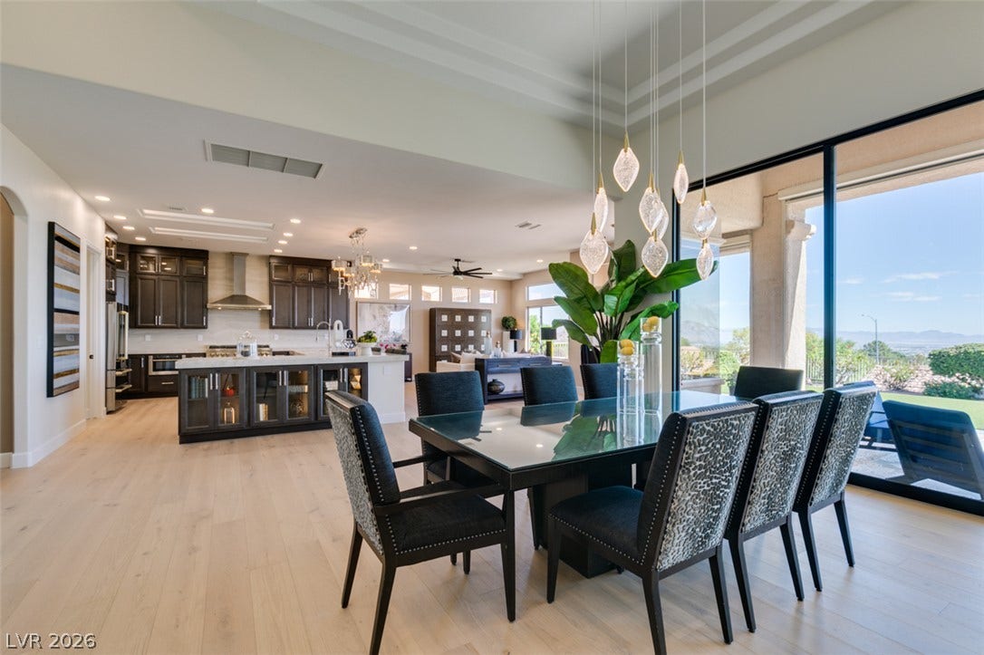 2532 Faiss Drive, Las Vegas, NV 89134 Soaring ceilings and light wood floors seamlessly connect the dining space with the kitchen.