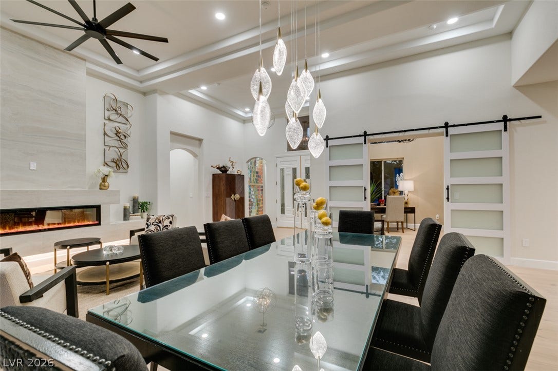 2532 Faiss Drive, Las Vegas, NV 89134 An elegant tray ceiling and custom sliding doors elevate this airy dining space.