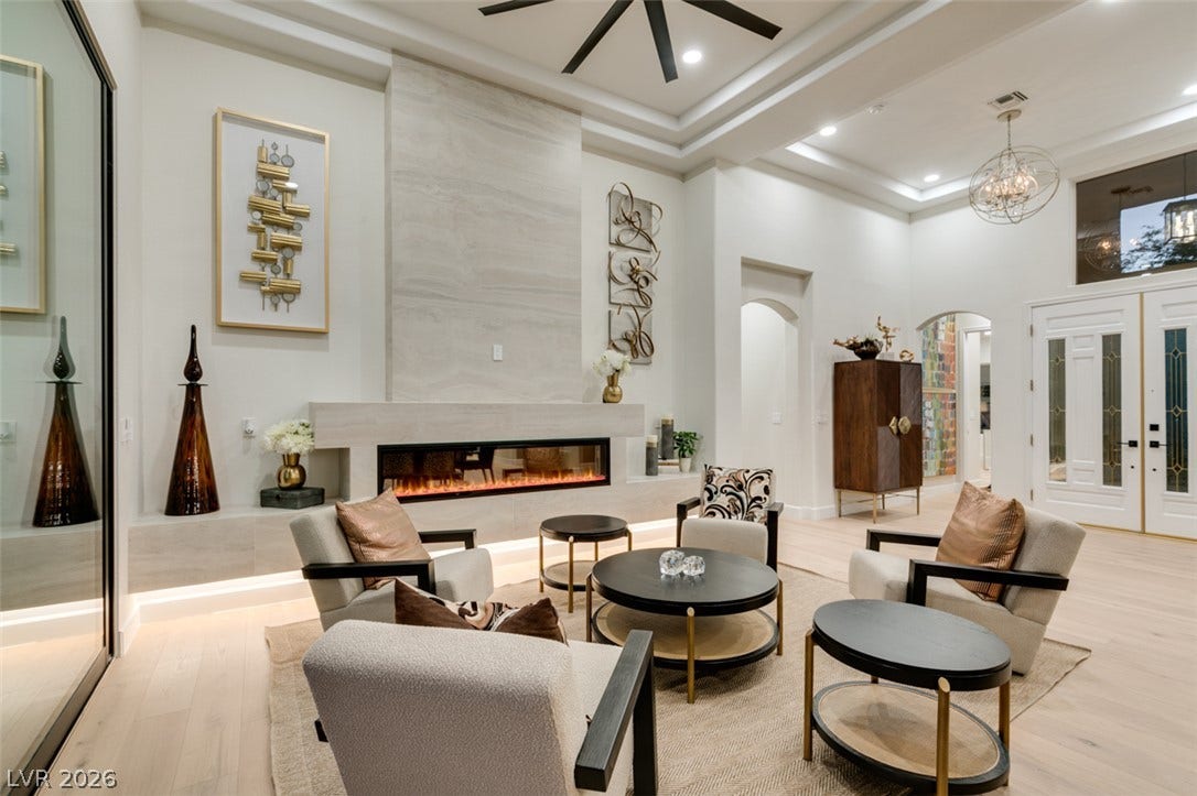 2532 Faiss Drive, Las Vegas, NV 89134 A modern fireplace acts as the centerpiece in this light-filled room with elegant tray ceilings.