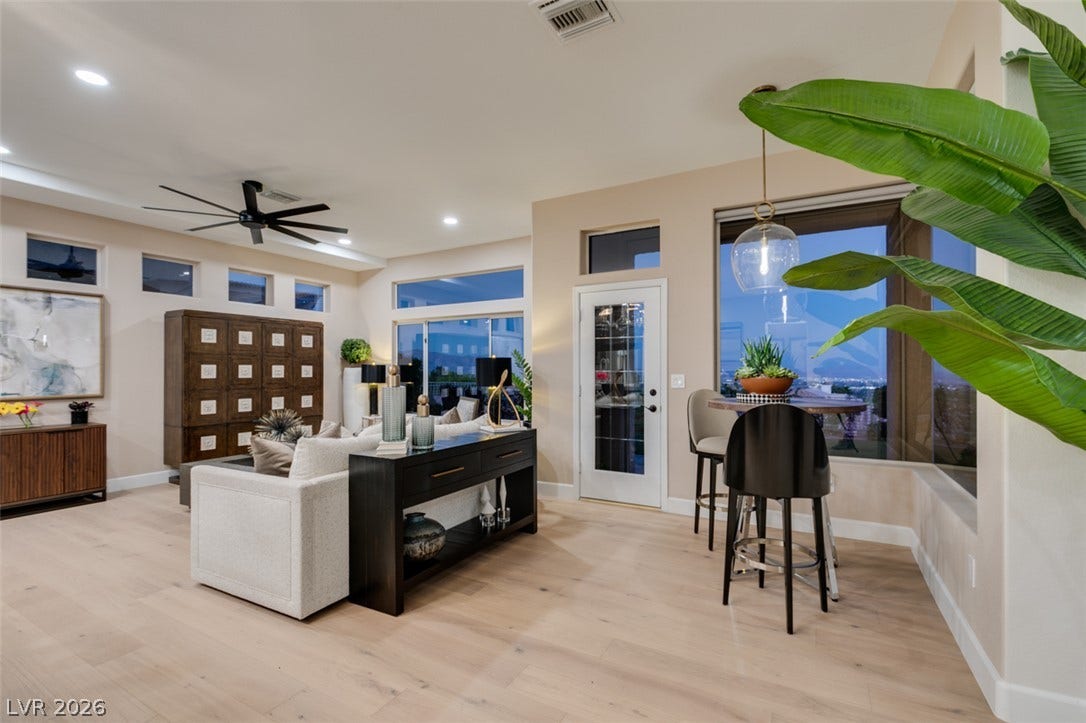 2532 Faiss Drive, Las Vegas, NV 89134 Gleaming hardwood floors and a modern open layout frame sweeping city light views through expansive windows.