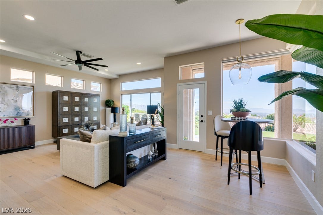 2532 Faiss Drive, Las Vegas, NV 89134 Hardwood floors and massive windows frame a bright, open living space.