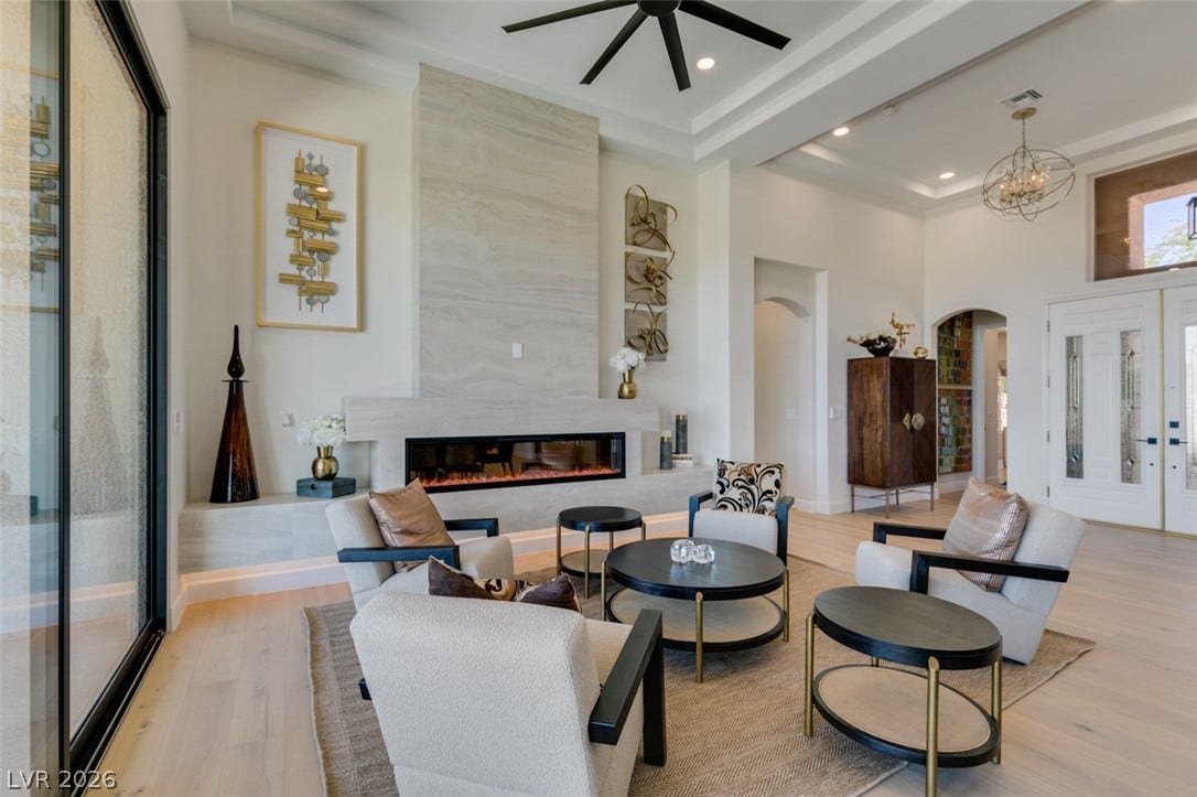 2532 Faiss Drive, Las Vegas, NV 89134 An elegant modern fireplace serves as the centerpiece of this light-filled main living space.
