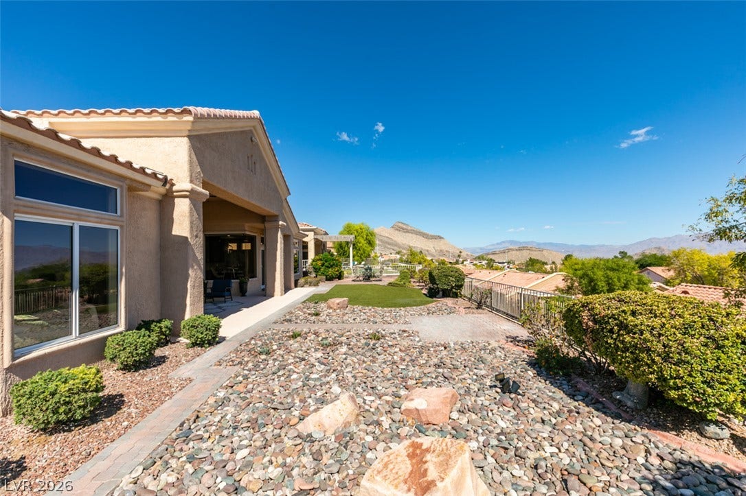 2532 Faiss Drive, Las Vegas, NV 89134 Low-maintenance desert landscaping frames a covered patio and distant mountain vistas.