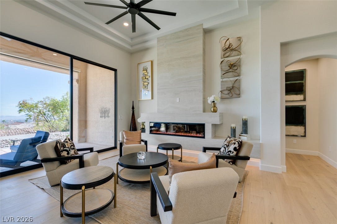 2532 Faiss Drive, Las Vegas, NV 89134 Hardwood floors and a modern stone fireplace define this elegant open living space.