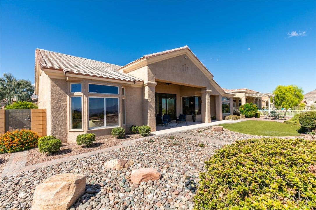 2532 Faiss Drive, Las Vegas, NV 89134 Clay tile roofing and desert-friendly landscaping surround this elegant single-level residence.