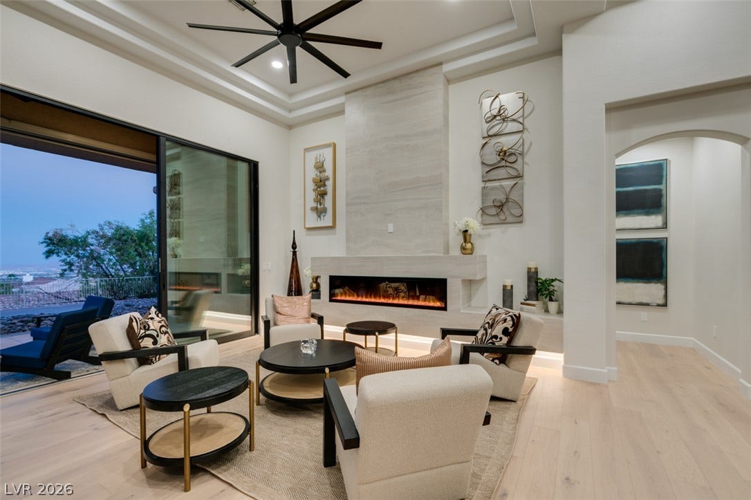 2532 Faiss Drive, Las Vegas, NV 89134 An elegant contemporary fireplace highlights this open living space with high recessed ceilings and hardwood floors.