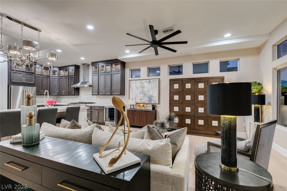 2532 Faiss Drive, Las Vegas, NV 89134 Polished hardwood flooring runs through an open floorplan connecting the living area and kitchen.