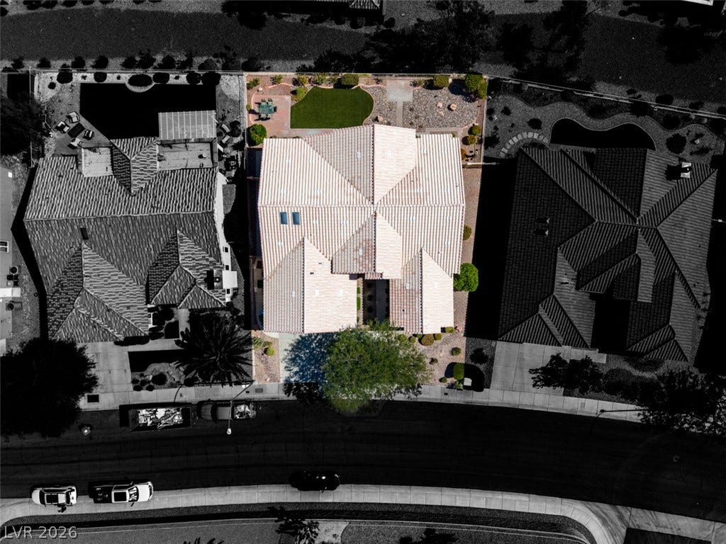 2532 Faiss Drive, Las Vegas, NV 89134 An aerial perspective showcases the tiled roofline and structured backyard of this desert home.