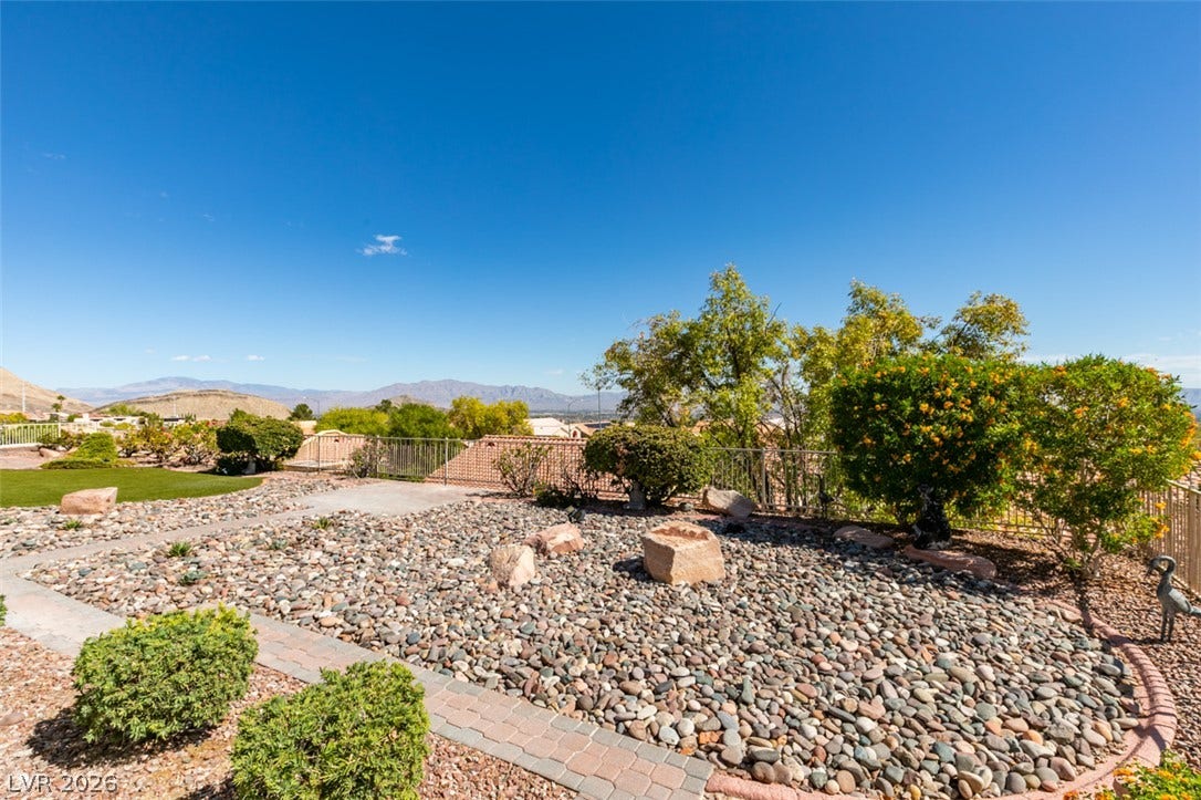2532 Faiss Drive, Las Vegas, NV 89134 Distant mountains frame the horizon beyond a meticulously landscaped rock garden.