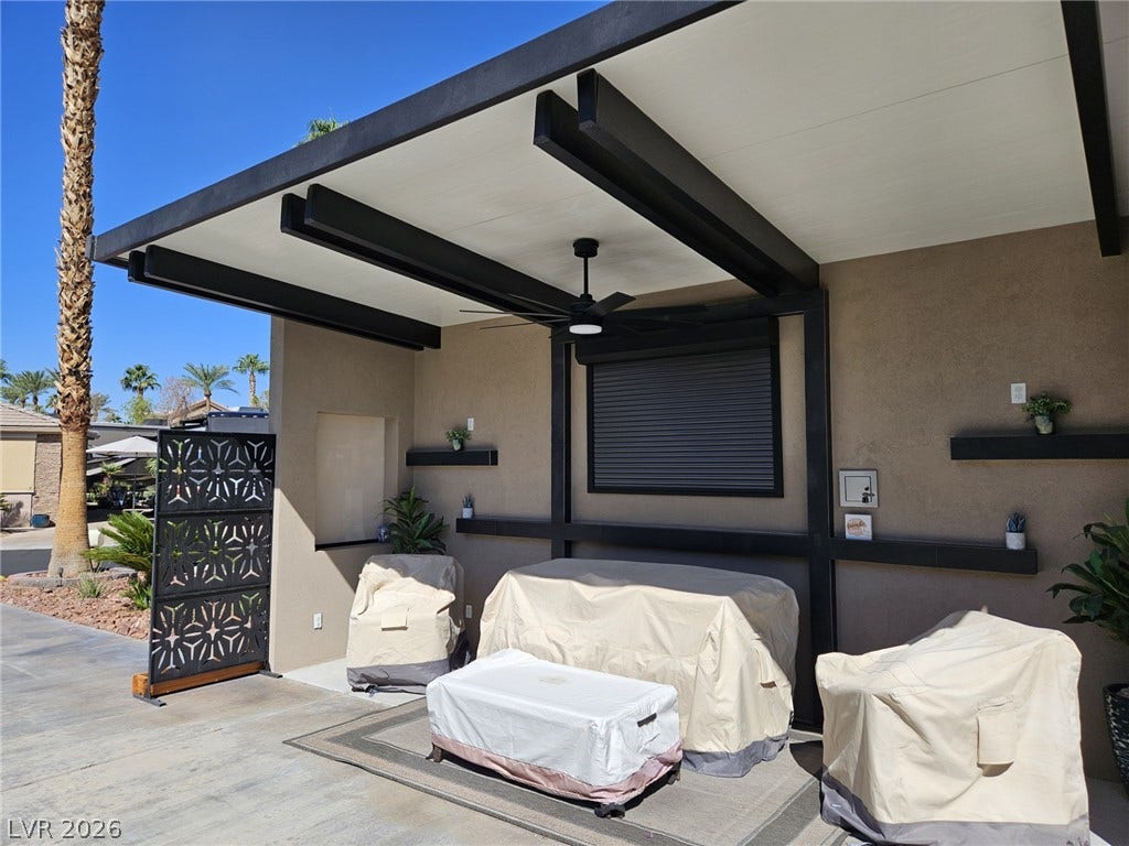 8175 Arville Street, #186, Las Vegas, NV 89139 Bold modern beams define a sheltered outdoor lounge space alongside smooth stucco walls.