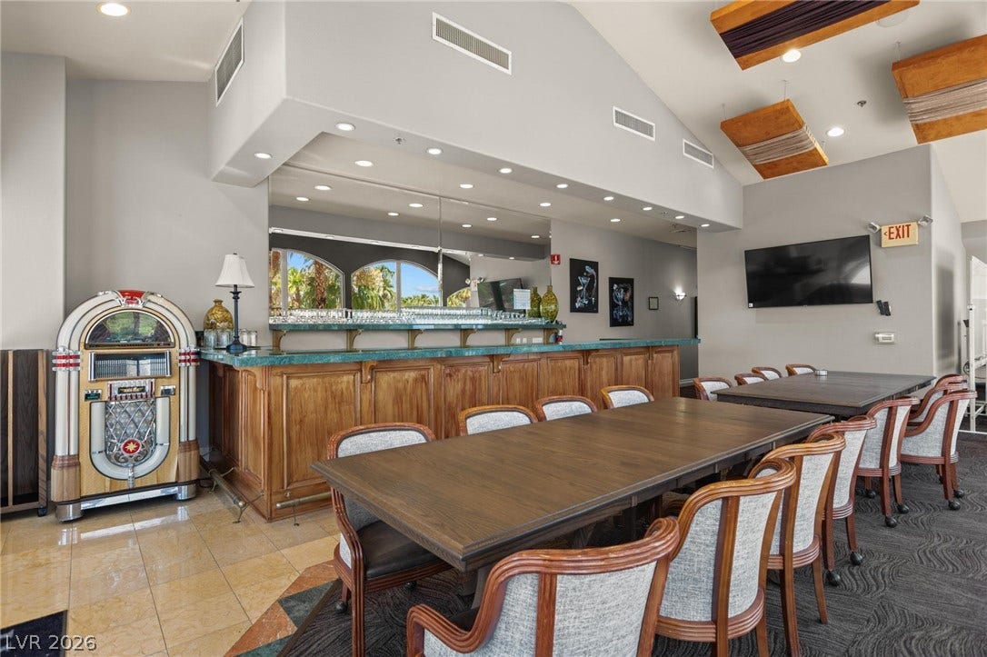 8175 Arville Street, #186, Las Vegas, NV 89139 A spacious built-in wet bar and gathering area under a vaulted ceiling with tile flooring.