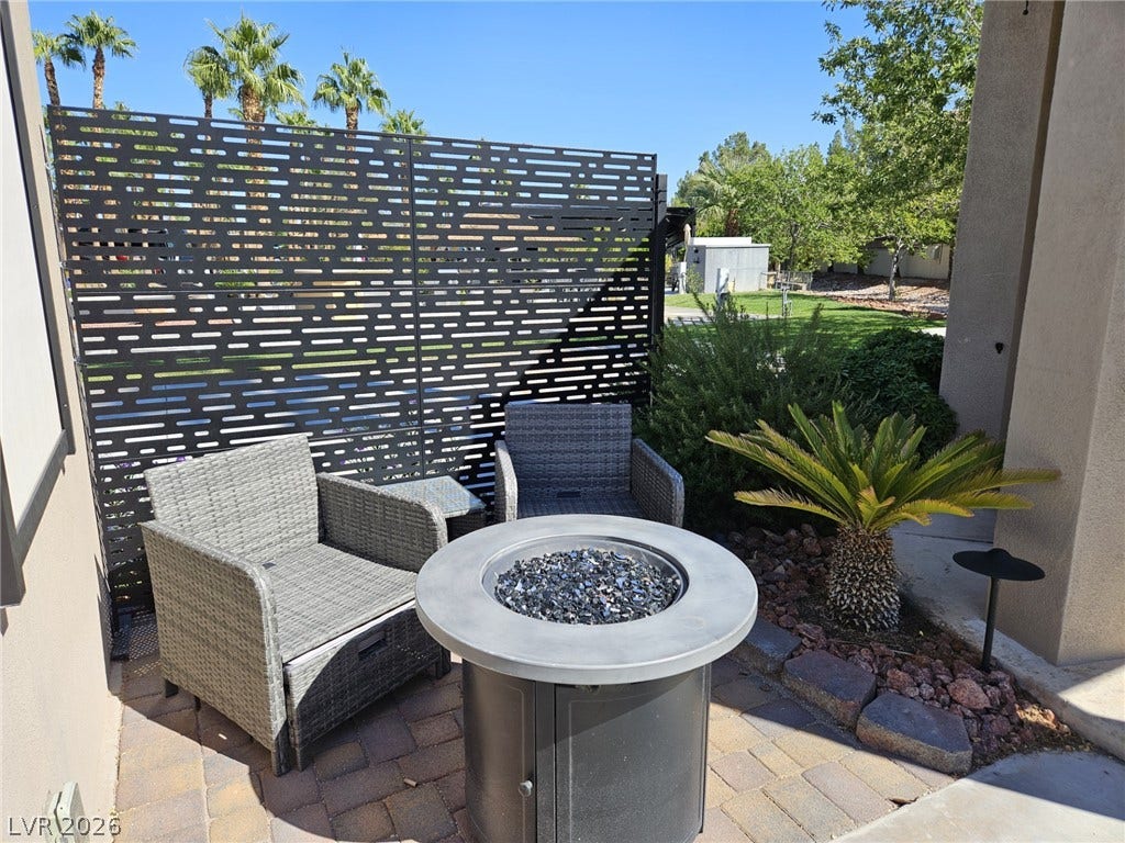 8175 Arville Street, #186, Las Vegas, NV 89139 A private stone paver patio features an integrated fire pit and custom privacy screening.