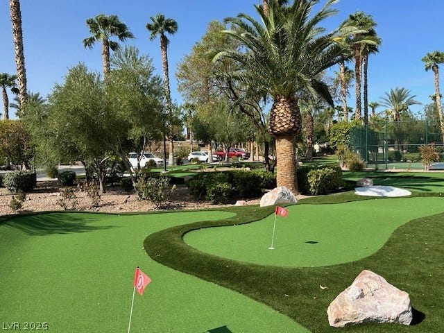 8175 Arville Street, #186, Las Vegas, NV 89139 Lush putting greens wind through towering palm trees under a bright desert sky.
