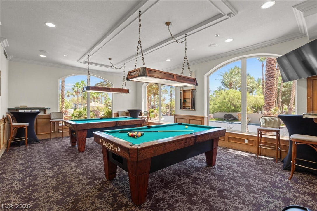 8175 Arville Street, #186, Las Vegas, NV 89139 Large arched windows frame leafy views in this light-filled entertainment space with patterned carpeting.