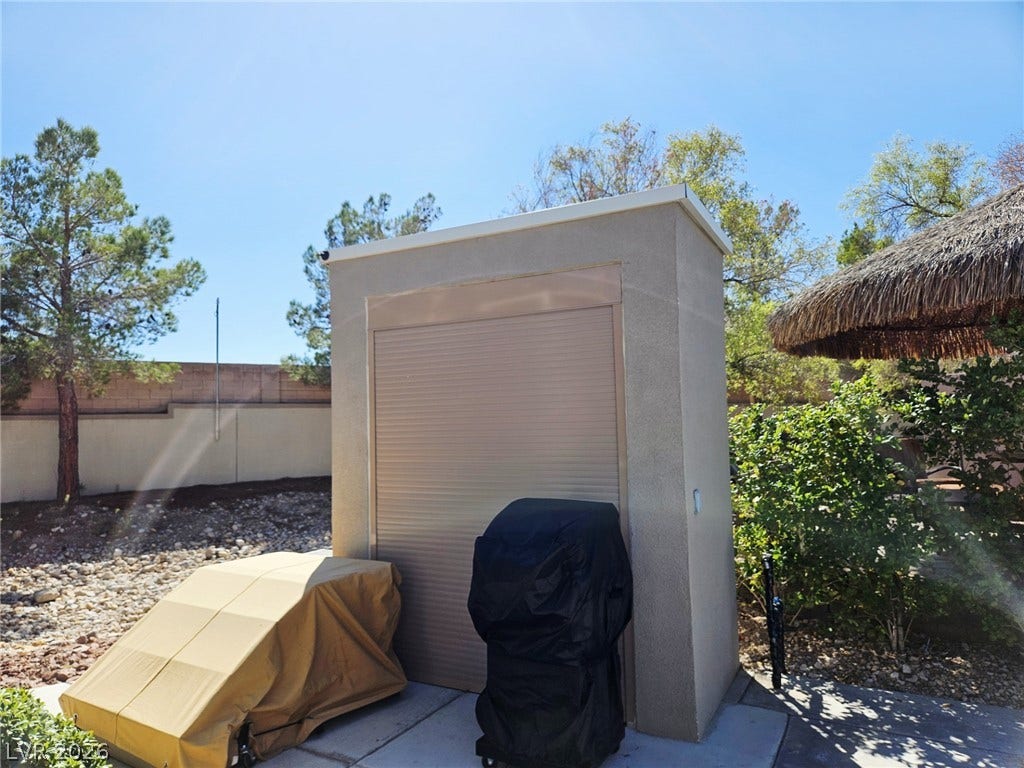 8175 Arville Street, #186, Las Vegas, NV 89139 A stucco storage building sits adjacent to a paved patio area in the backyard.