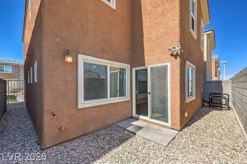 4134 San Cuervo Way, Las Vegas, NV 89115 A low-maintenance gravel yard wraps around this multi-level stucco home.