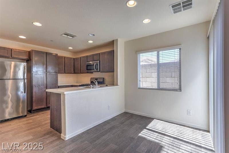 4134 San Cuervo Way, Las Vegas, NV 89115 An open kitchen and dining layout integrates smooth hard-surface flooring with classic recessed lighting.