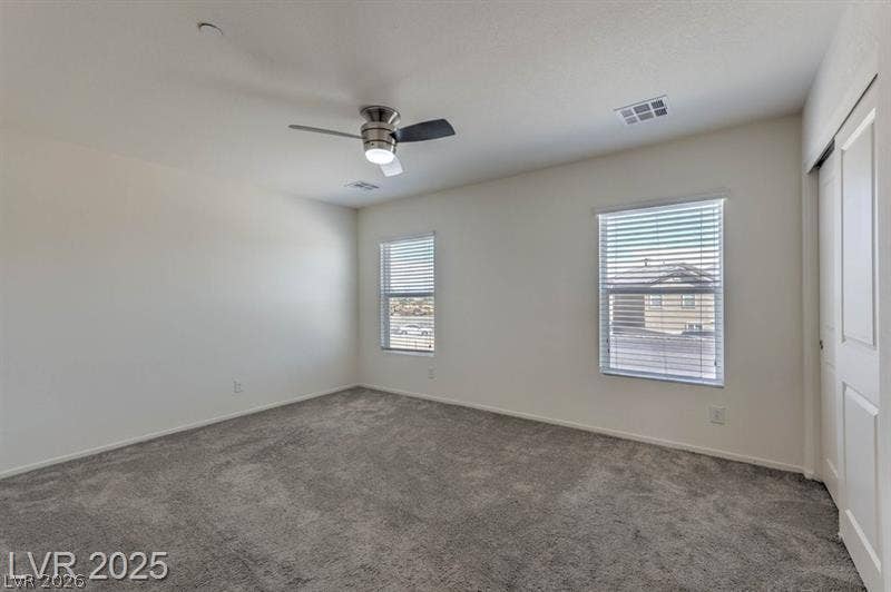 4134 San Cuervo Way, Las Vegas, NV 89115 Plush carpeting and multiple windows enhance this versatile secondary bedroom space.