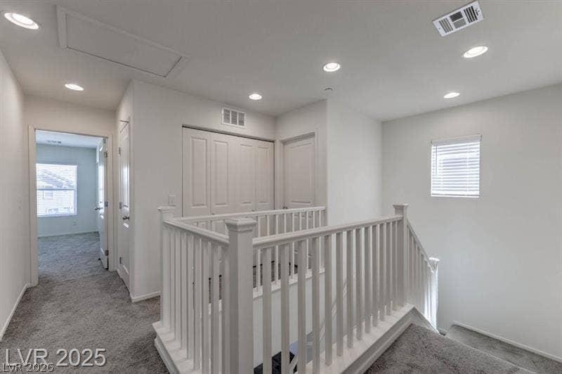 4134 San Cuervo Way, Las Vegas, NV 89115 An upper-level landing connects rooms with plush carpeting and modern recessed lighting.