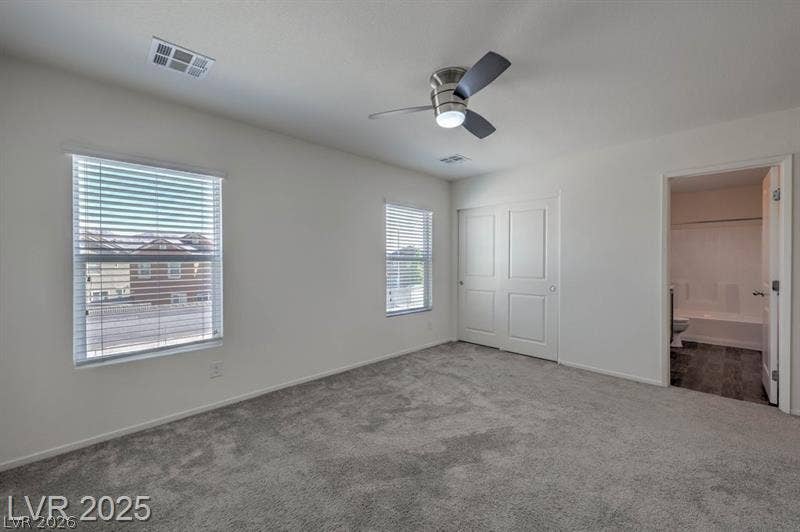 4134 San Cuervo Way, Las Vegas, NV 89115 Plush carpeting and large windows enhance this comfortable upstairs bedroom suite.