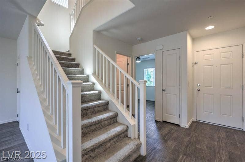 4134 San Cuervo Way, Las Vegas, NV 89115 Carpeted stairs with white balusters accent the entry foyer of this multi-level home.