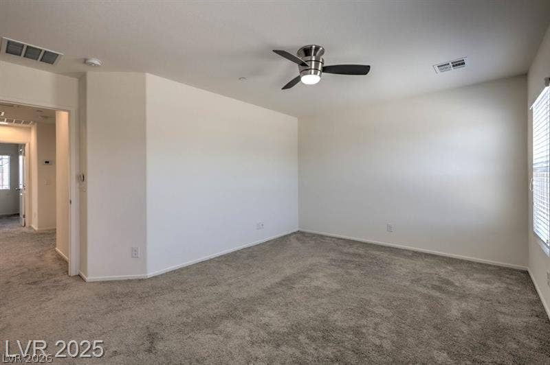 4134 San Cuervo Way, Las Vegas, NV 89115 Plush wall-to-wall carpeting and clean lines define this versatile secondary bedroom space.
