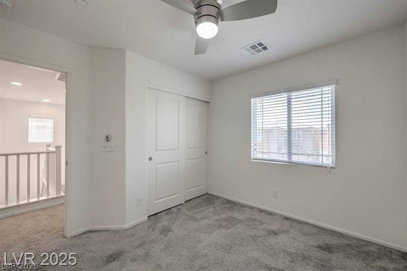 4134 San Cuervo Way, Las Vegas, NV 89115 Soft carpeting pairs with a multi-panel sliding closet in this comfortable upper-level room.