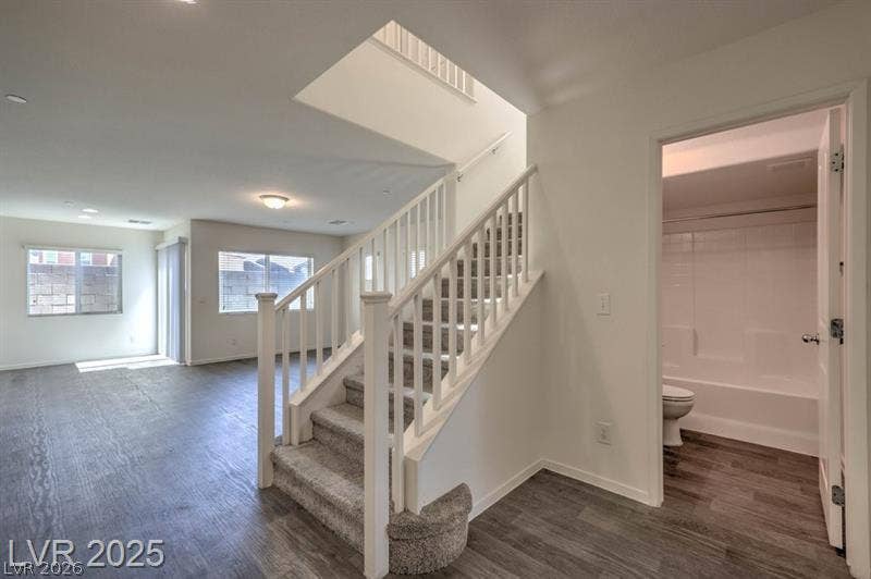 4134 San Cuervo Way, Las Vegas, NV 89115 Clean lines and wood-look flooring define this open layout featuring a central staircase.