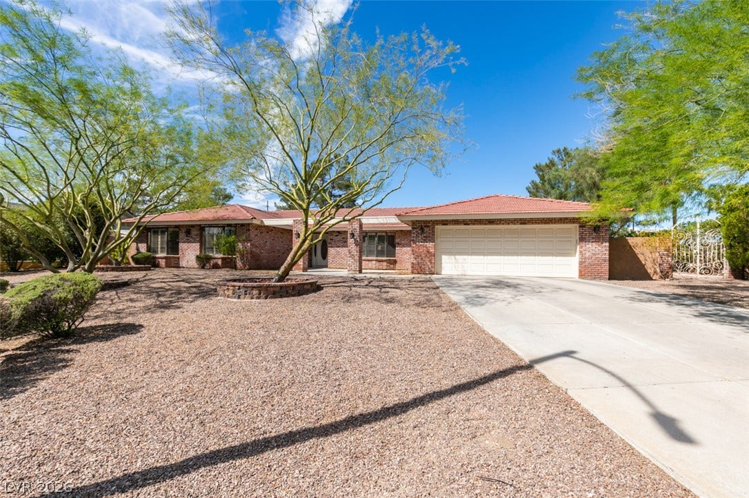 2246 Almart Circle, Henderson, NV 89014 Mature trees shade the low-maintenance desert landscaping leading up to this classic brick home.