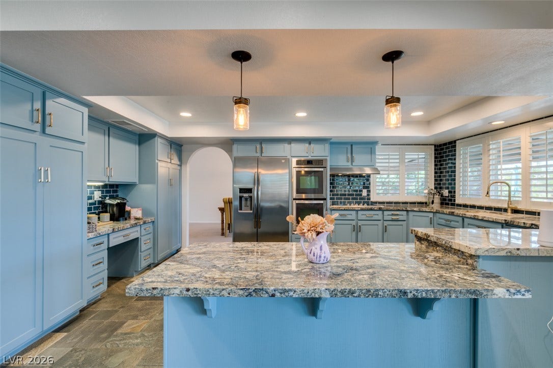 2246 Almart Circle, Henderson, NV 89014 Gleaming stone countertops and custom cabinetry define this thoughtfully designed culinary space.