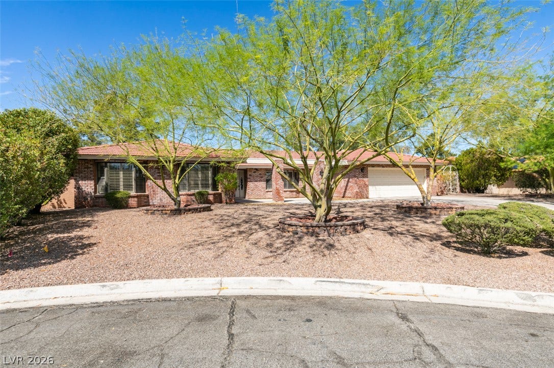 2246 Almart Circle, Henderson, NV 89014 Established desert plantings shade the classic brick exterior of this single-story home.
