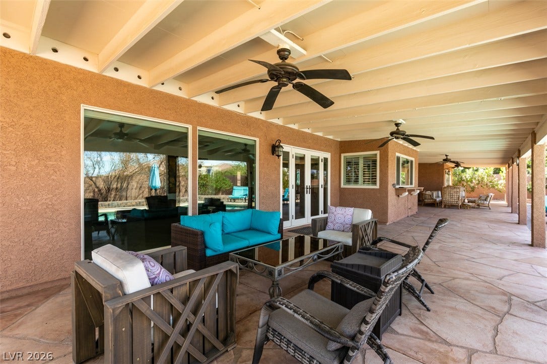 2246 Almart Circle, Henderson, NV 89014 Exposed beams span the ceiling above a flagstone patio bordering stucco walls.