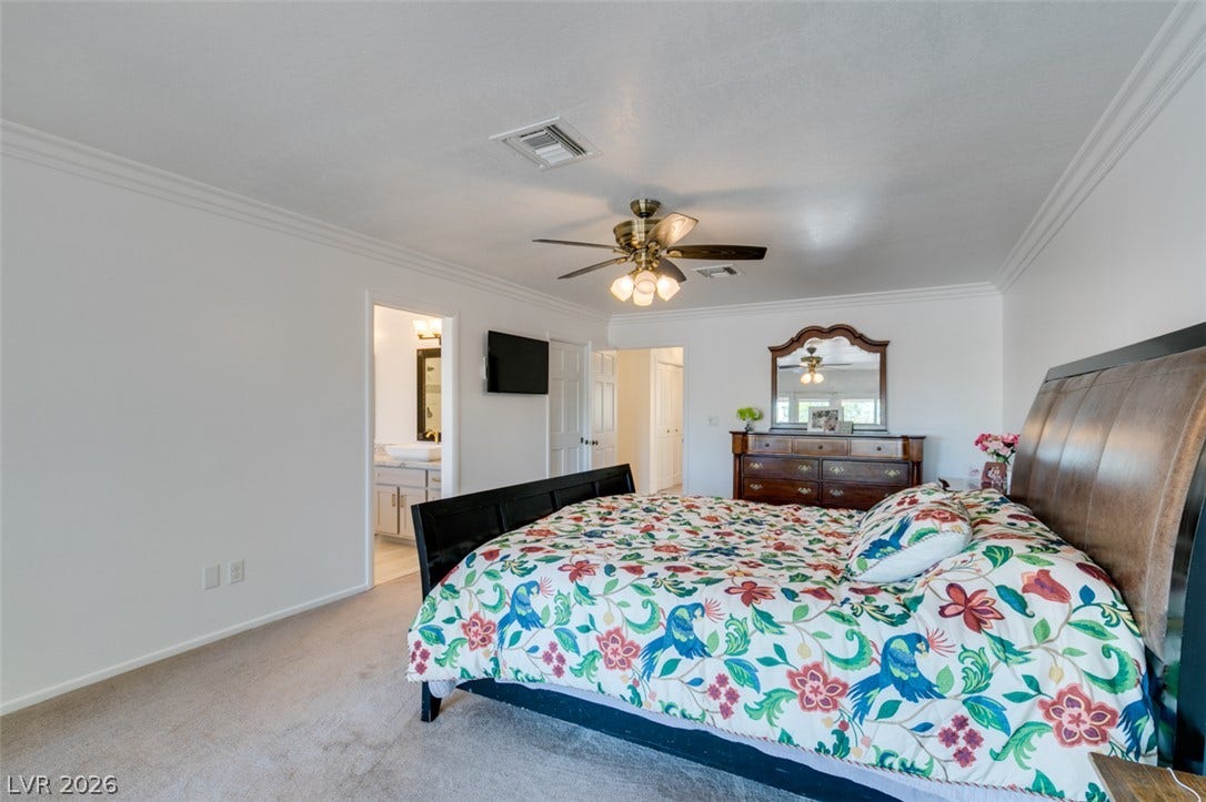 2246 Almart Circle, Henderson, NV 89014 Plush carpeting underfoot and clean crown molding create a classic atmosphere in this master bedroom.