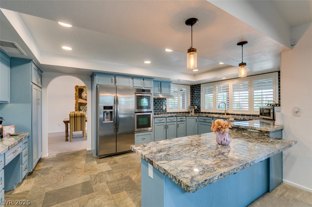 2246 Almart Circle, Henderson, NV 89014 Granite countertops and customized cabinetry highlight this expansive cooking space.