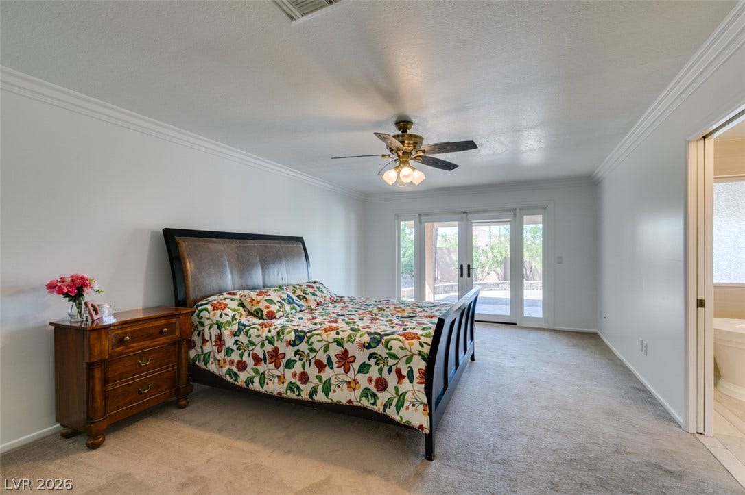 2246 Almart Circle, Henderson, NV 89014 Crown molding and plush carpeting define this spacious bedroom featuring access to the outdoors.