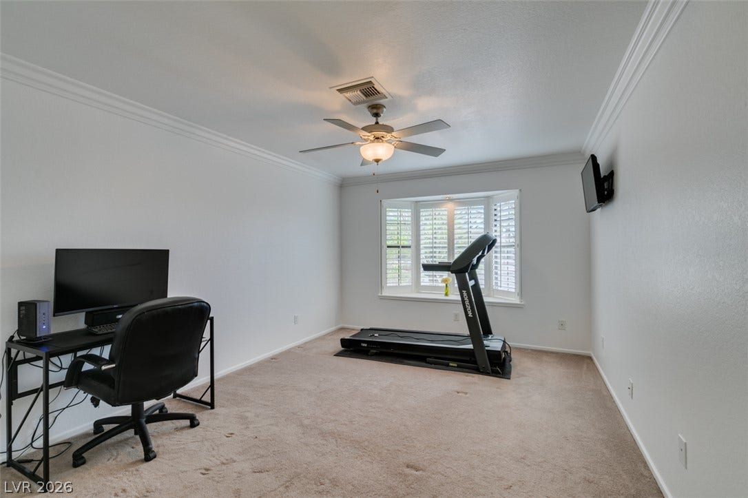 2246 Almart Circle, Henderson, NV 89014 Crown molding and carpet elevate this versatile room complete with a bay window.